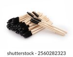 Black and wooden eyelash brushes on white background, beauty accessories, eyelash extensions, eyelash lamination