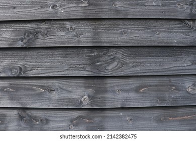 Black Wooden Panels Of Weatherboard Shed Wall