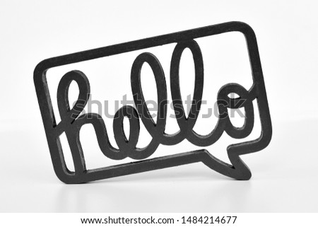 Black wooden sign with the word 'Hello' written in cursive letters on white background