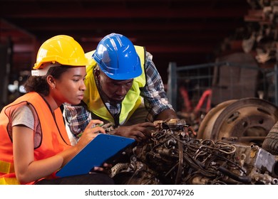 Black Worker Working At Warehouse Factory. Portrait Worker And Engineer Under Inspection Production Process On Factory. 