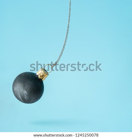 Black wrecking ball Christmas bauble decoration. Minimal New Year concept.