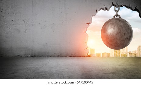 A black wrecking ball hanging inside the opening in a concrete wall showing city landscape. Old building demolition. New construction site. Freshen up your life.
