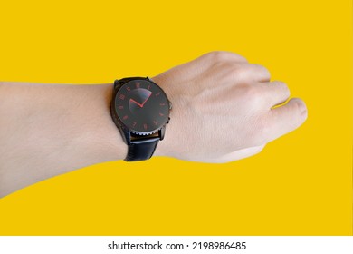 Black Wristwatch Representing Speed And The Rapid Passage Of Time. Fast Passing Time. Isolated Yellow Background