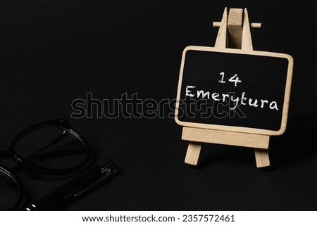 a black writing board on a wooden stand and a black background, the inscription 