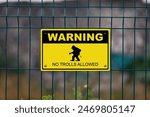 Black and yellow warning sign with a troll with written bellow it "No trolls allowed".