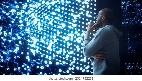 Black Young Man Looking at a Big Screen with Neural Network Visualisation In 3D. Professional Computer Data Science Engineer Working in System Control and Monitoring Telecommunications Office
