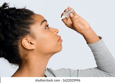 Black Young Woman Applying Ophthalmology Eyedropper, Side View. Glaucoma Eye Prevention, Human Vision Serum Wash