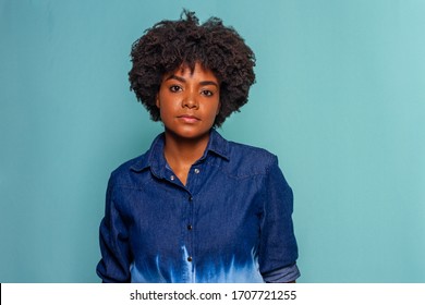 Black Young Woman With Black Power Hair Wearing Blue Jeans Shirt