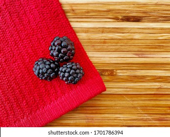 Blackberries On A Wooden Kitchen Counter. Ingredients For Baking A Summer Berry, Strawberry And Blackberry Pie Or Tart. Top Down Flat Lay View. Colorful Ripe Summery Food With Copy Space.