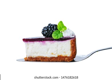 Blackberry Cheesecake Slice On Cake Cutter Isolated On White. No-bake Cheesecake With Graham Cracker Crust, Cream Cheese Filling And Blackberry Jelly, Decorated With Whipped Cream.