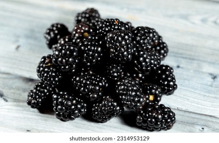 Blackberry, edible fruit of many species in genus Rubus in the family Rosaceae, hybrids among species with subgenus Rubus, and hybrids between the subgenera Rubus and Idaeobatus, Pile of blackberries - Shutterstock ID 2314953129