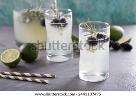 Blackberry lime and rosemary refreshing lemonade in tall glasses