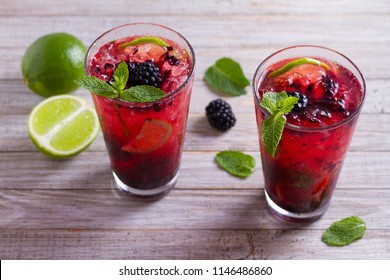 Blackberry mojito cocktail with berries, lime and mint. Summer berry cocktail 