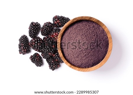 Blackberry powder in wooden bowl and fresh blackberries isolated on white background, top view, flat lay.