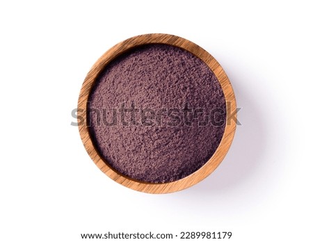 Blackberry powder in wooden bowl isolated on white background. Top view, flat lay.