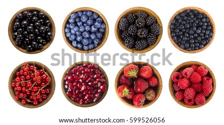 Black-blue and red berries isolated on white background. Collage of different fruits and berries. Blueberry, blackberry, cherry, strawberry, currant and raspberry. Top view.
