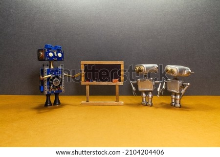 Blackboard classroom and learning technology. Robot professor teacher mentor gestures while giving a lecture. Two students bots near the chalkboard are listening to the lesson. Futuristic education.
