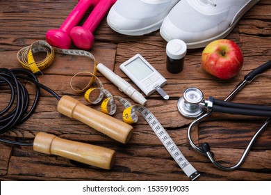 Blackboard With Diabetes Word Near Sports Equipment And Glucometer. Diabetes And Exercise Concept