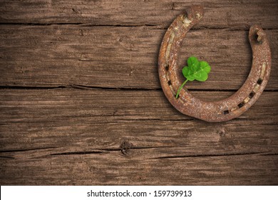 Blackboard With Four-leaved Clover And A Horse Shoe