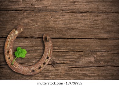 Blackboard With Four-leaved Clover And A Horse Shoe