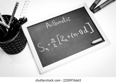 Blackboard with hand written Sequences and Series Formulas and geometric shapes and figures