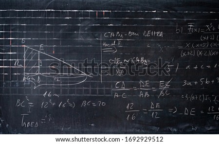 Blackboard inscribed with scientific formulas and calculations in mathematics. Science and education background.