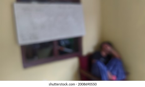 A Blackboard With Someone Who Is Grieving And With A Blur Effect