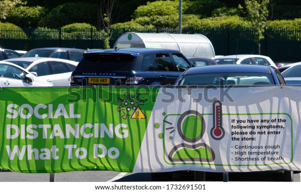 Blackburn, Lancashire/UK - May 6th 2020: Social\
distancing what to do sign on car park barriers at Asda supermarket\
during COVID-19 coronavirus\
pandemic