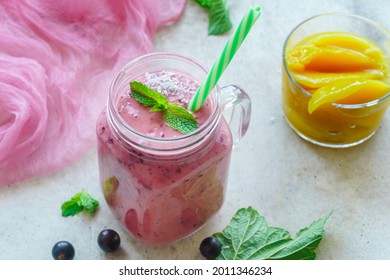 Blackcurrant Smoothie With Mango, Coconut Milk And Mint On Table