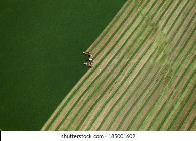 Blackfoot, Idaho, USA Aug. 7, 2012 An Aerial View Of Farm Machinery Harvesting Hay In An Alfalfa Field