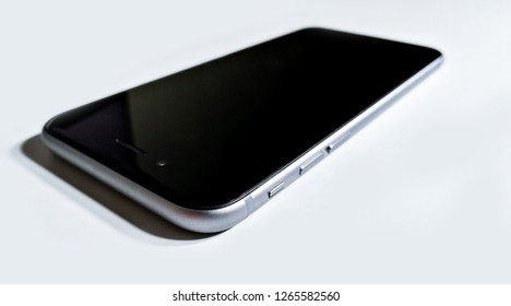 Black-gray Mobile Phone Laying Down On White Surface