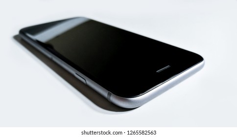 Black-gray Mobile Phone Laying Down On White Surface