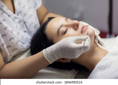 Blackhead Cleansing On Woman Face During Facial Treatment At Beauty Clinic. Professional Acne Extraction Procedure By Dermatologist. Healthcare And Beauty Concept