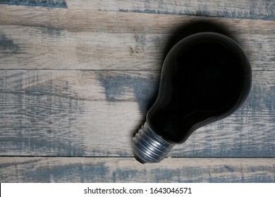 A Blacklight Light Bulb On Wooden Background