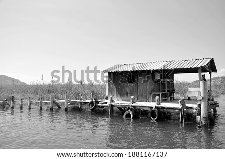 Blacknwhite wooden river fishing hut