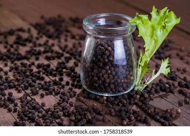 A lot of blackpeppers on wooden background