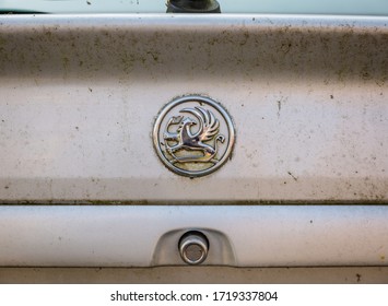 Blackpool, England, 19/04/20 Rear Vauxhall Logo On A Very Dirty Messy Car That Has Not Been Cleaned In Years On An Astra G Mk Mark 4 With Boot Opening Button Close Up On Logo 