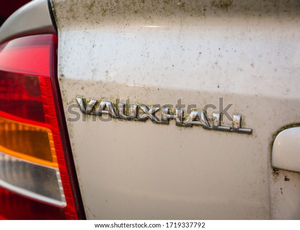 Blackpool, England,
19/04/20 Rear vauxhall logo on a very dirty messy car that has not
been cleaned in years on an astra G mk mark 4 with boot opening
button close up on logo
