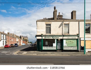 Blackpool, England, UK - August 1, 2015: Beaty's Kitchen Cafe And Bistro, A Traditional Northern English Cafe, Stands Next To An Empty Boarded-up Shop And Terraced Houses In Recession-hit Fleetwood.