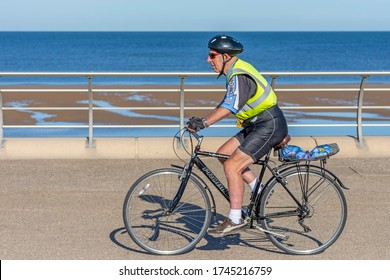 Blackpool , Lancashire/England - 30/05/2020 - Biker Wearing Hi Viz Vest And Black Helmet