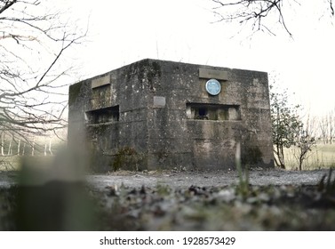 blackpool, uk 03.03.2021 A brutalist cold gritty concrete world war two, ww2, pillbox war bunker defence fortress in a dirty forgotten woodland. wartime relics and forgotten outposts