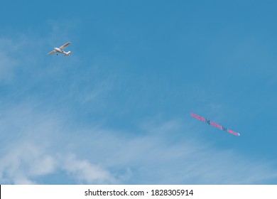 BLACKPOOL, UK - AUGUST 7, 2020: A small Cessna plane skywriting, pulling standard letter banner 'remember the Sabbath Day' Christian message