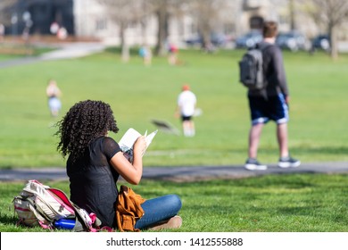 Blacksburg, USA - April 18, 2018: Virginia Tech Polytechnic Institute And State University College Campus With Student Sitting Reading Book On Grass