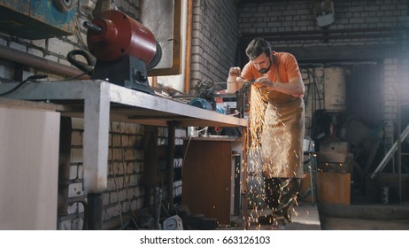 Blacksmith Checks The Thickness Of The Sharpening