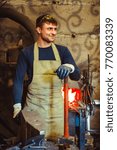 the blacksmith is at the forge