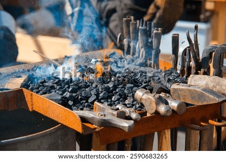 blacksmith forge with burning coal and metal tools
