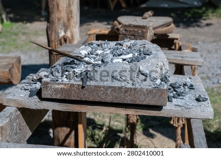Blacksmith forge with coal and ash, ready for traditional metalworking and ancient craft production
