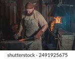 Blacksmith forges a red-hot metal piece on an anvil in a rural forge. Traditional crafts