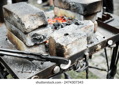 Blacksmith furnace with hot red coal . Blacksmith's tongs on home made Forge  - Powered by Shutterstock