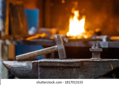 Blacksmith Hammer On The Anvil Against The Background Of Fire